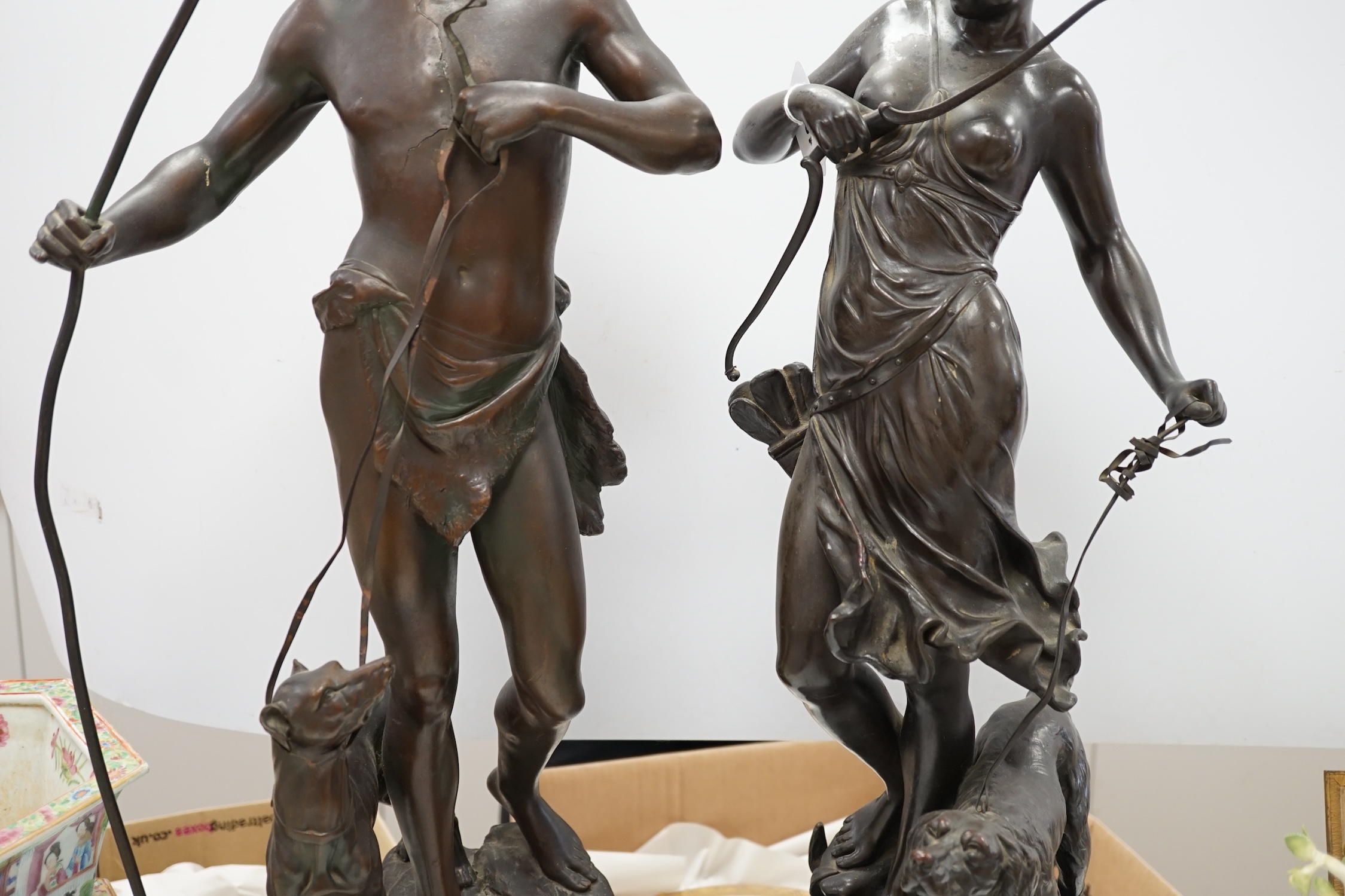 A pair of late 19th century French patinated electrotype figures of a huntsman and Diana, 72cm. Condition - poor to fair